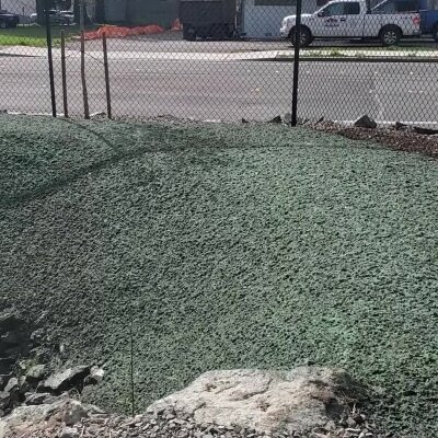 Hydroseeding process on a sloped ground for grass cultivation.