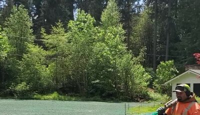 Worker hydroseeding lawn in Washington state.