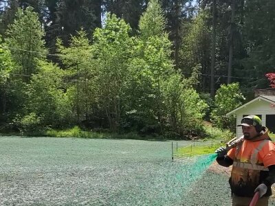 Worker hydroseeding lawn in Washington state.