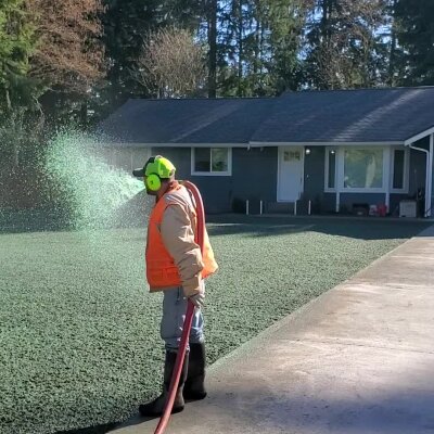 Worker hydroseeding lawn in Washington state.