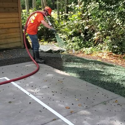 Hydroseed installer applying mixture to residential lawn in Washington State.