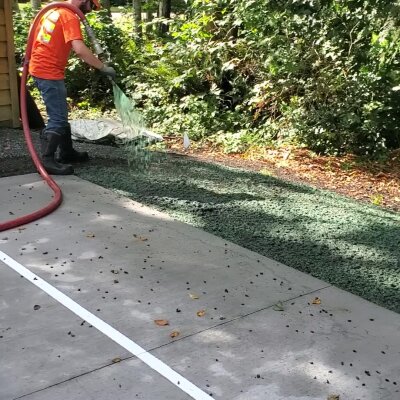 Hydroseeding technician applying slurry to soil in Washington State.